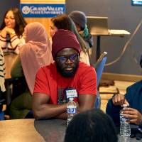 International Anchor Allies Winter 2026 First Mixer - a smiling crew member listening as another member makes a point